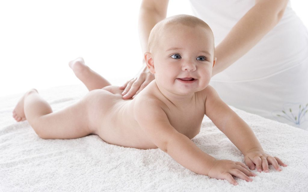 Mother massaging baby
